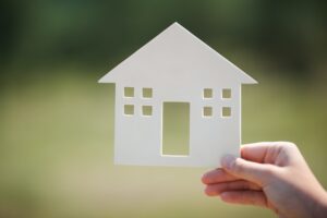 Hand holding house model outdoor